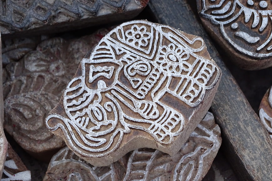 Traditional wooden block printing stamp with intricate carved patterns