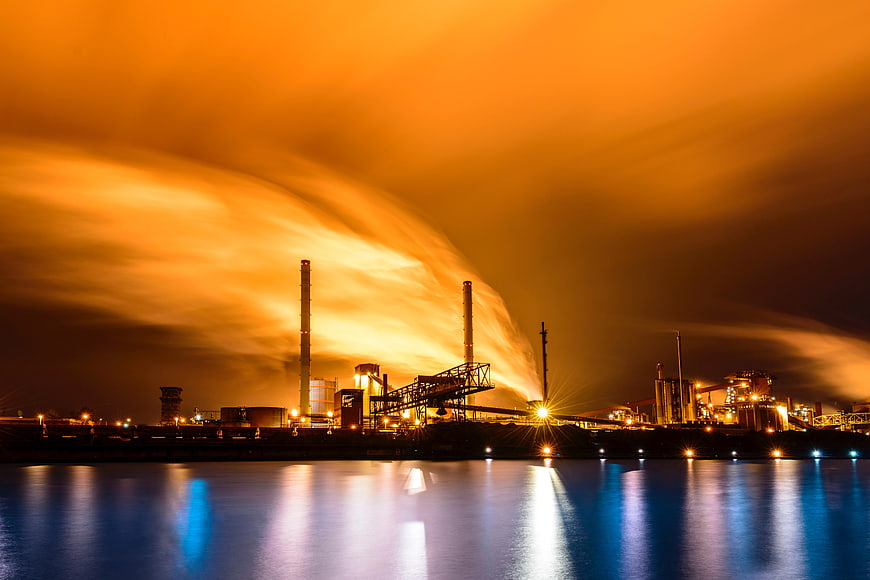 Industrial Factory Smoke Plume at Night Over Water