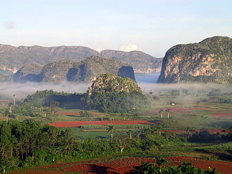 Misty Mountain Landscape With Agricultural Fields And Lush Greenery