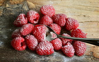 Fresh Raspberries With Powdered Sugar On Rustic Wooden Surface