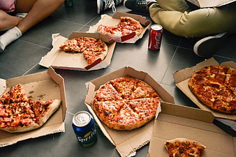 Group of friends eating pizza on the floor