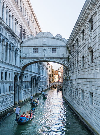 Gondolas passing under the Bridge of Sighs in Venice