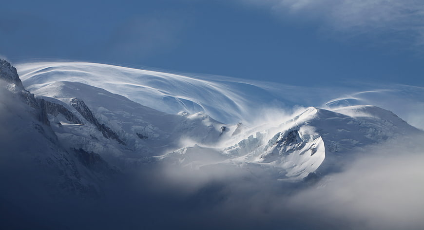 Dramatic Snow-Capped Mountain Peak with Wind-Blown Snow