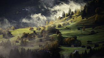 Misty Morning Alpine Landscape with Rolling Hills and Village