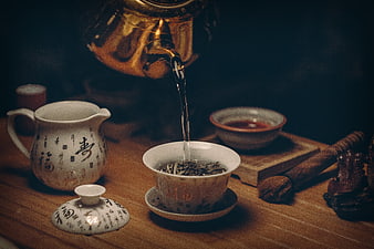 Pouring hot water into traditional Chinese tea cup