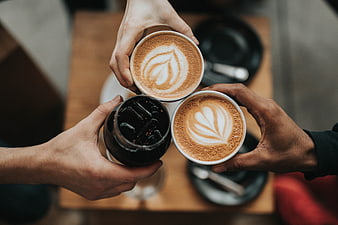 Top View of Hands Toasting with Coffee Cups