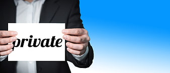 Businessman holding white card with private text against blue background