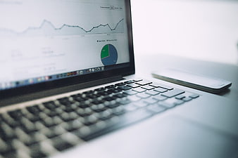 Laptop displaying analytics charts and graphs on screen