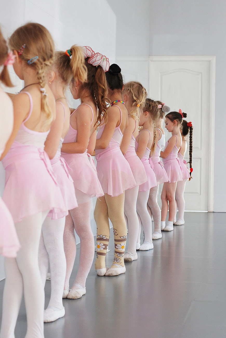 Young Girls in Pink Ballet Tutus Lined Up in Dance Studio