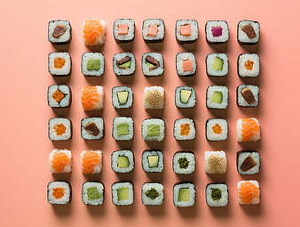 Top View Assorted Sushi Rolls on Pastel Pink Background