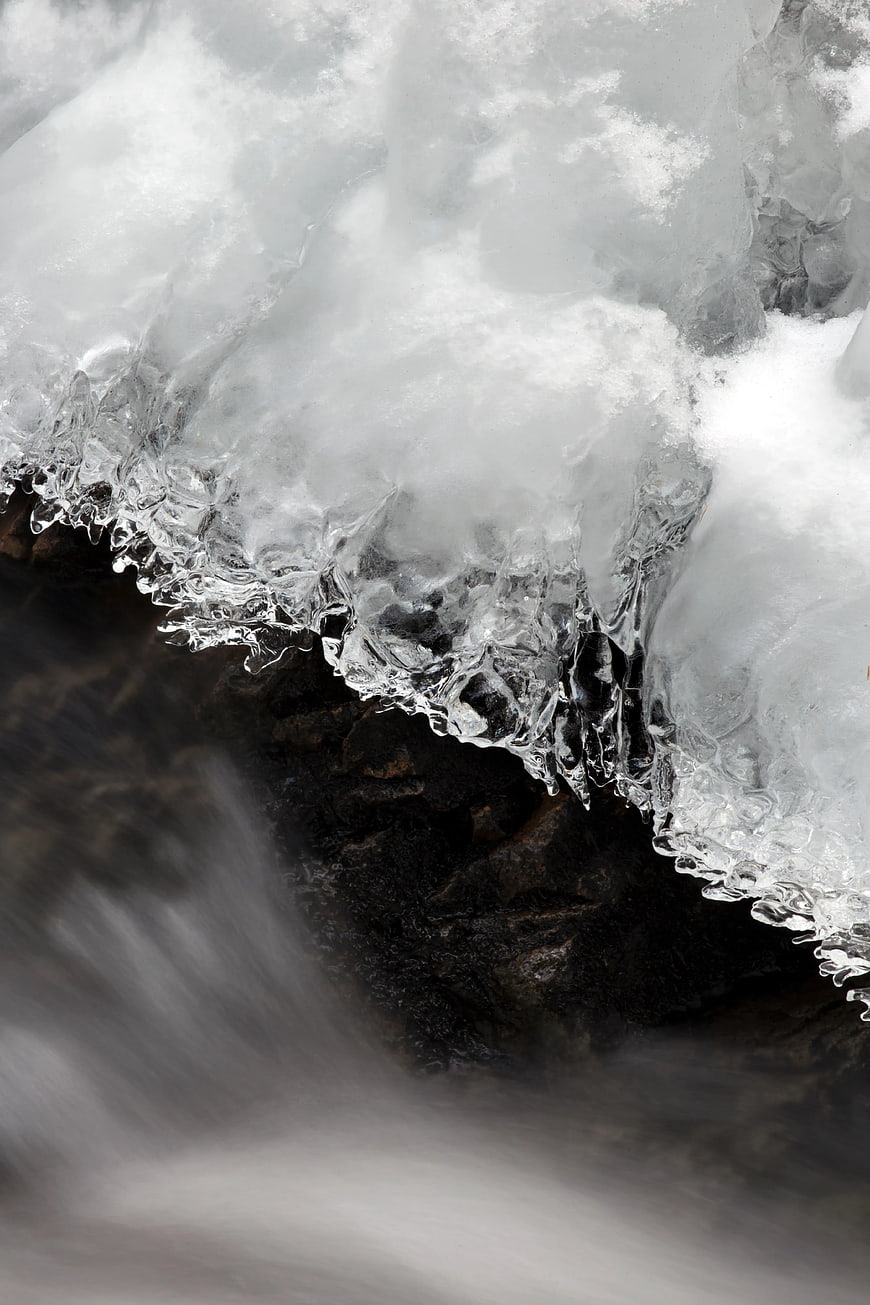 Frozen Icicle Edge Over Flowing Water