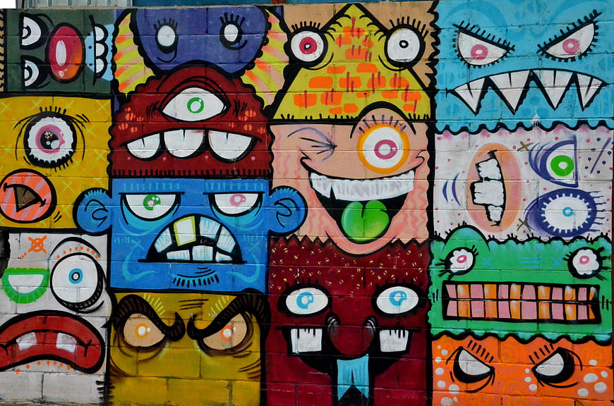 Colorful Street Art Mural Featuring Whimsical Monster Faces