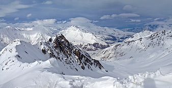 Snow-Covered Mountain Peaks and Glaciers in Winter Landscape