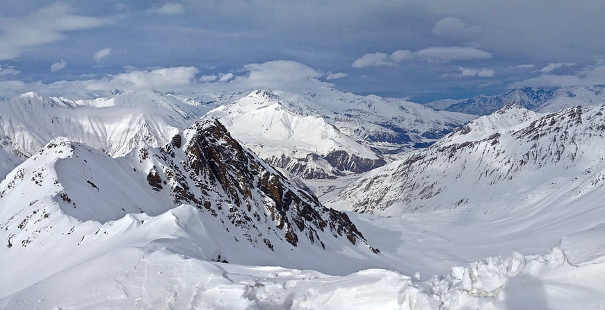 Snow-Covered Mountain Peaks and Glaciers in Winter Landscape