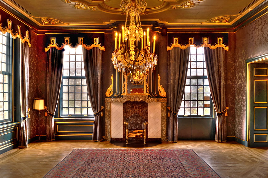 Luxurious vintage room with ornate chandelier and fireplace