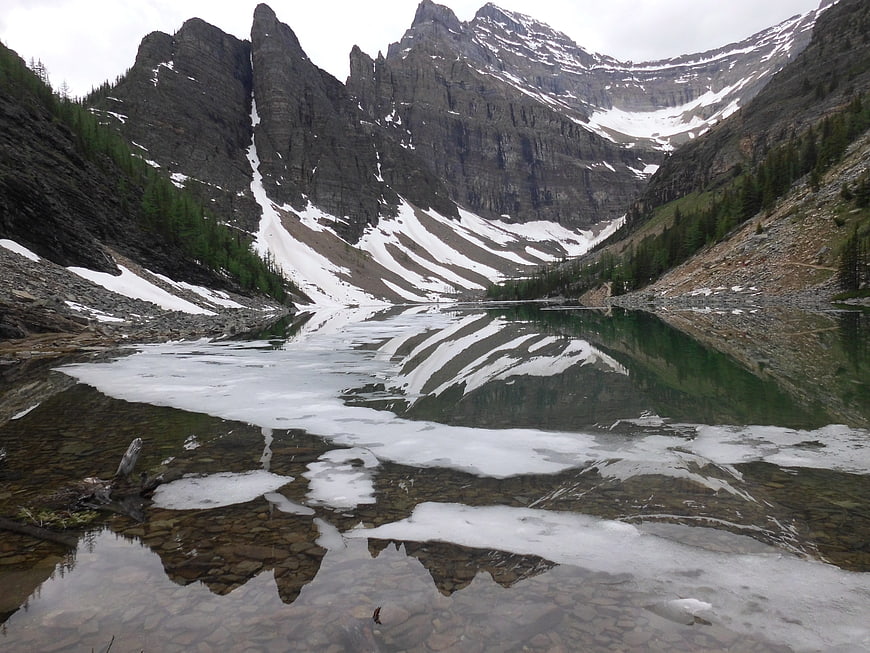 Mountain lake with ice and snow reflections in Canada
