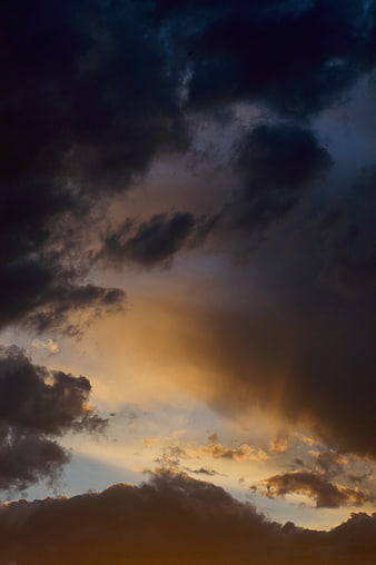 Dramatic Dark Clouds with Golden Sunlight at Dusk