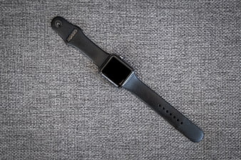 Black Smartwatch on Textured Gray Fabric Background