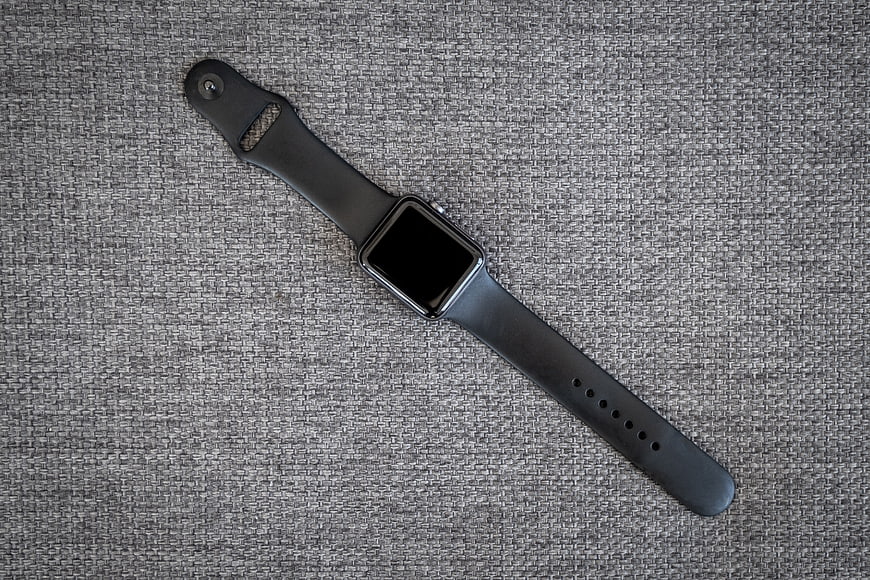 Black Smartwatch on Textured Gray Fabric Background