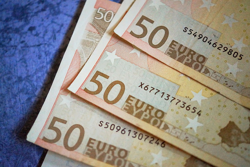 Close-up of 50 Euro banknotes on blue background