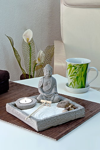 Zen meditation tray with Buddha statue, candle, and calla lilies
