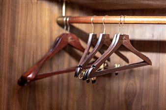 Empty wooden hangers in a luxury wardrobe closet interior
