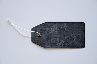 Black Textured Price Tag with White String on White Background