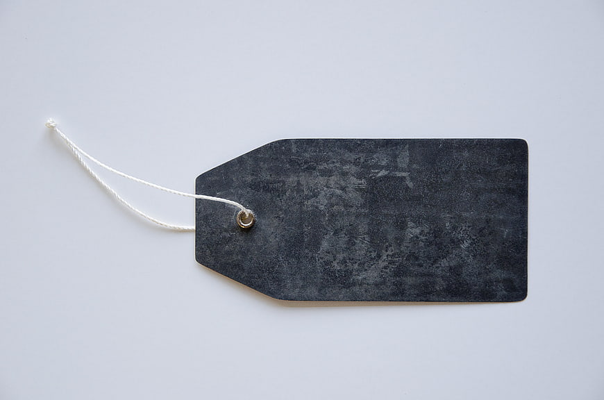 Black Textured Price Tag with White String on White Background