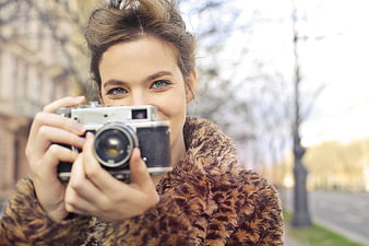 Woman with Vintage Camera in Leopard Print Coat