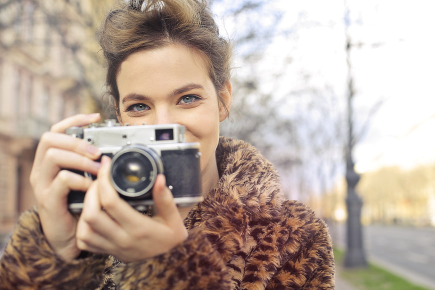 Woman with Vintage Camera in Leopard Print Coat