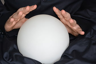 Hands holding white crystal ball for fortune telling