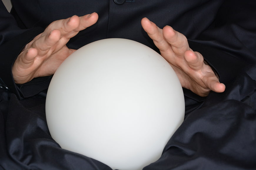 Hands holding white crystal ball for fortune telling