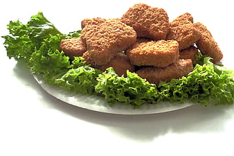 Golden Fried Chicken Nuggets on White Plate with Lettuce