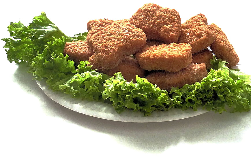 Golden Fried Chicken Nuggets on White Plate with Lettuce