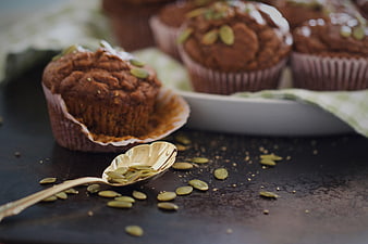 Homemade Pumpkin Muffins with Seeds on Dark Table