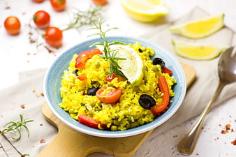 Vegetable Rice Bowl with Lemon, Tomatoes, and Rosemary Garnish
