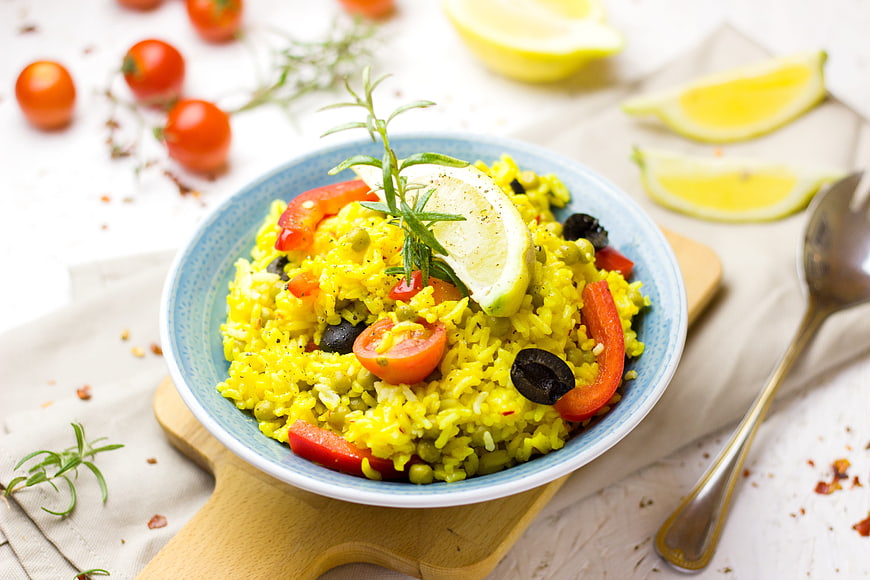 Vegetable Rice Bowl with Lemon, Tomatoes, and Rosemary Garnish