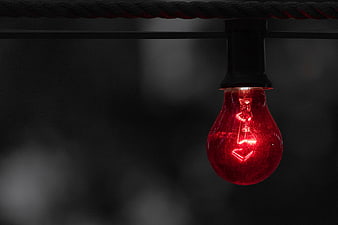 Glowing Red Light Bulb Hanging on Black Wire