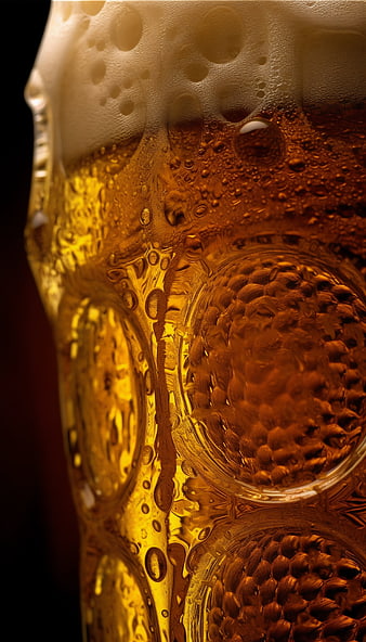 Close-up of cold beer in textured glass with condensation