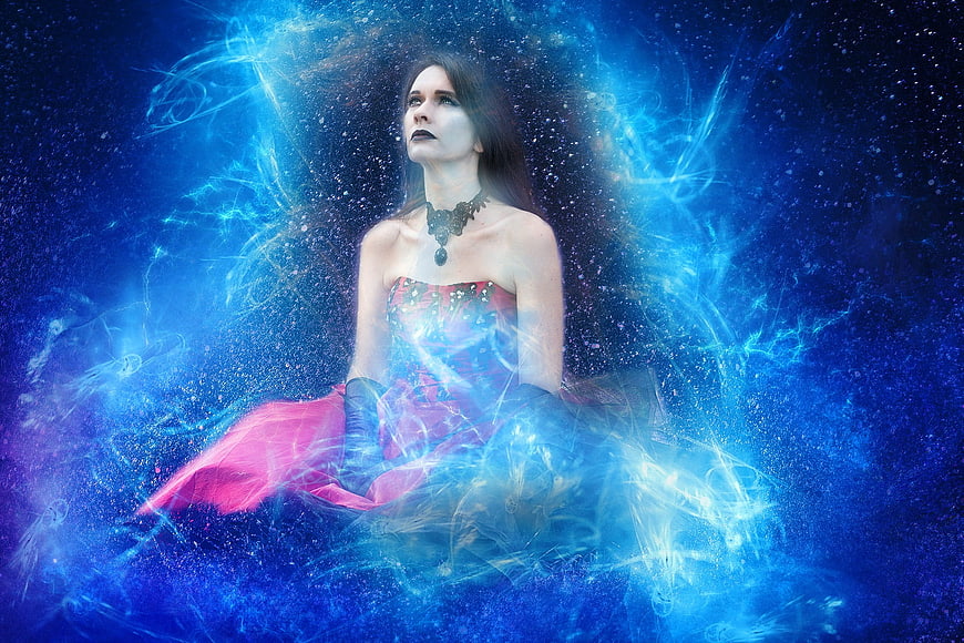 Mystical woman in pink dress surrounded by blue cosmic energy