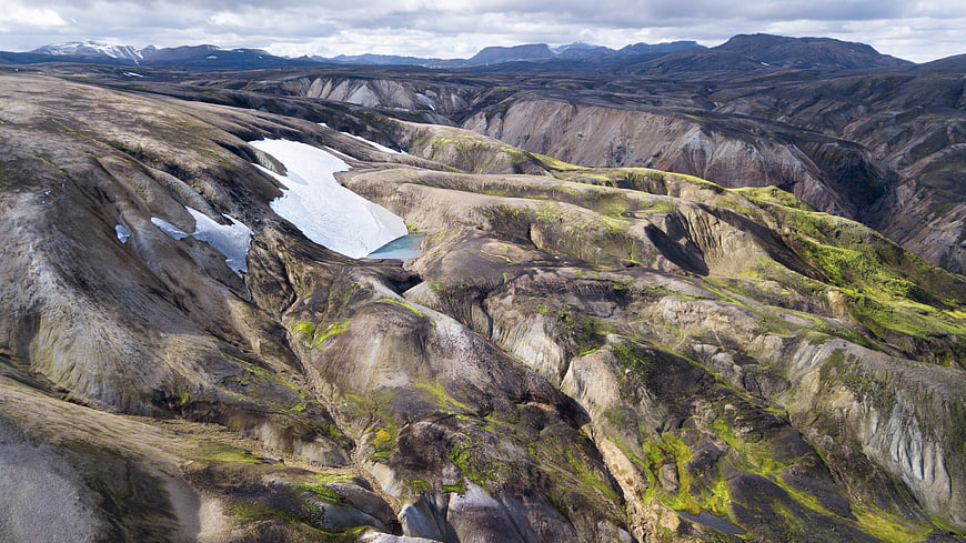 Aerial View of Dramatic Icelandic Mountain Landscape with Snow Patches