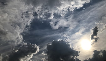 Dramatic Sunlight Breaking Through Dark Storm Clouds
