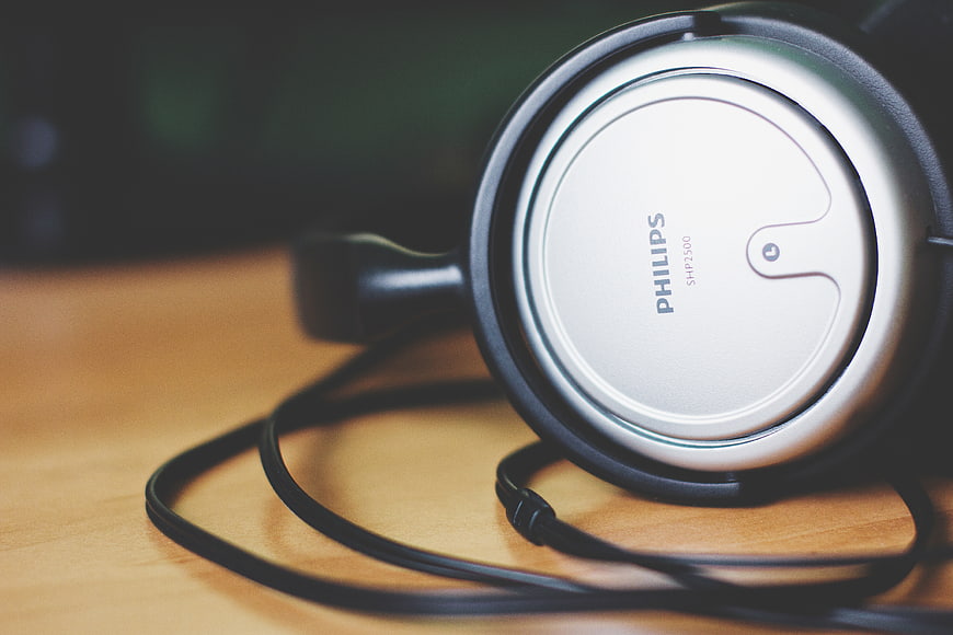 Close-up of Philips headphones on wooden desk