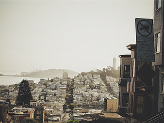 San Francisco Cityscape with Foggy Sky and Street Sign