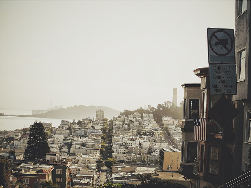 San Francisco Cityscape with Foggy Sky and Street Sign