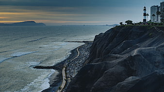 Aerial View of Coastal Highway and Lighthouse at Dusk