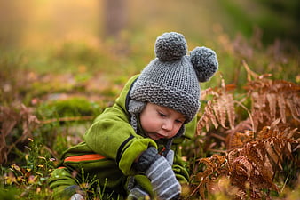 Toddler Boy in Knit Hat Playing in Autumn Forest