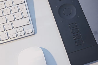 Minimalist workspace with keyboard, mouse, and graphics tablet