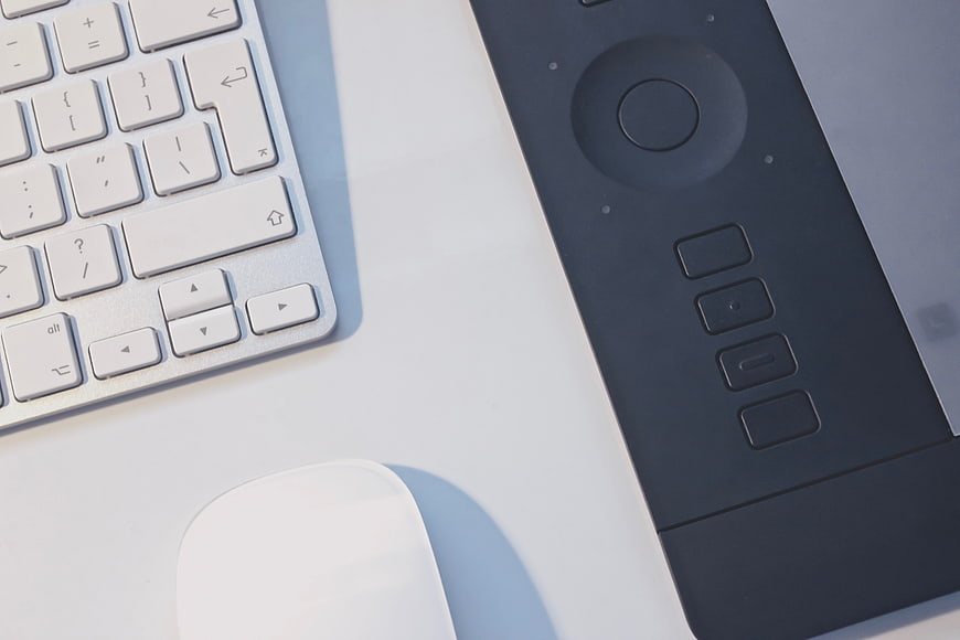 Minimalist workspace with keyboard, mouse, and graphics tablet