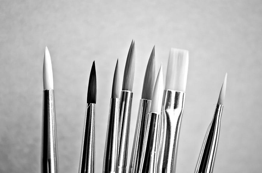 Black and white close-up of assorted paintbrush tips